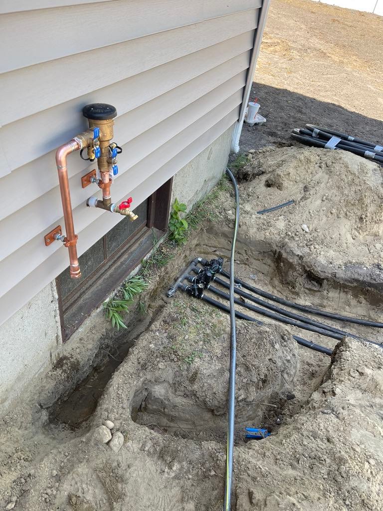 Copper backflow preventer and zone manifold installed on residential irrigation system in Lynn, MA