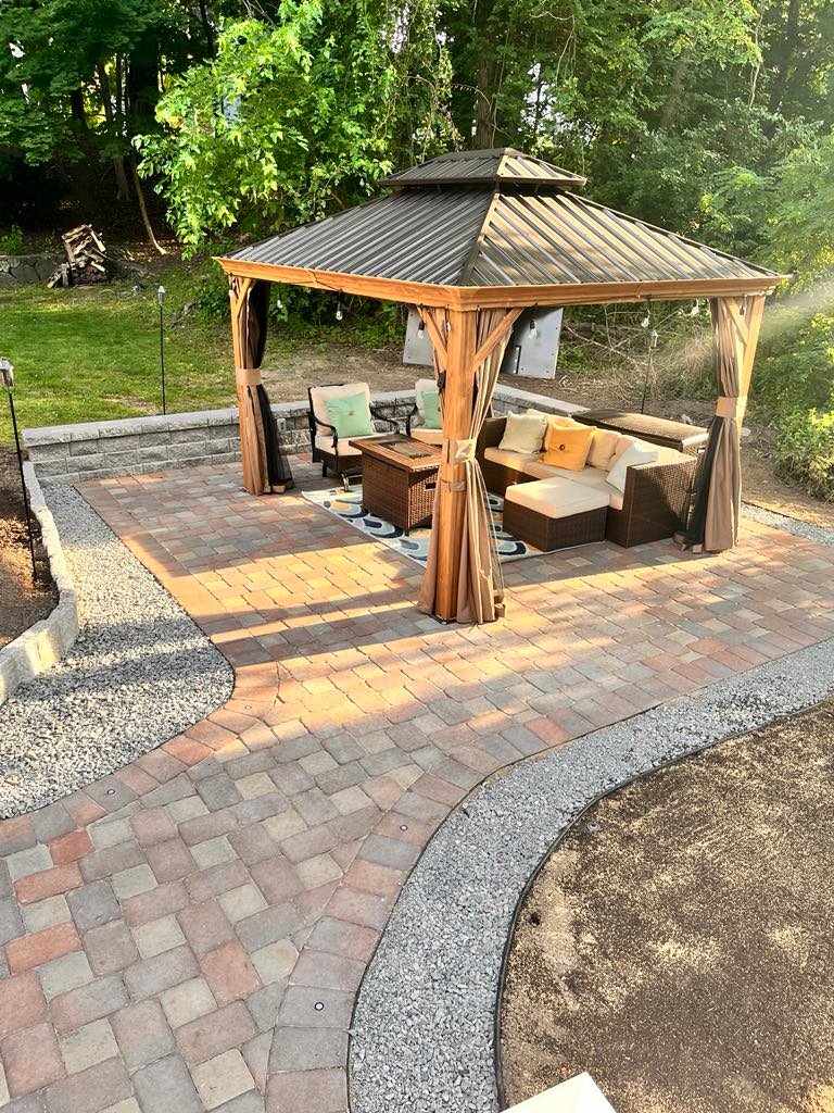 Completed paver patio with hardwood gazebo and outdoor lounge furniture in Swampscott, MA