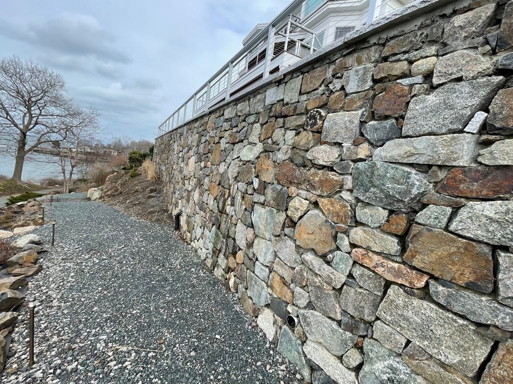Large natural fieldstone retaining wall on oceanfront property in Nahant, MA